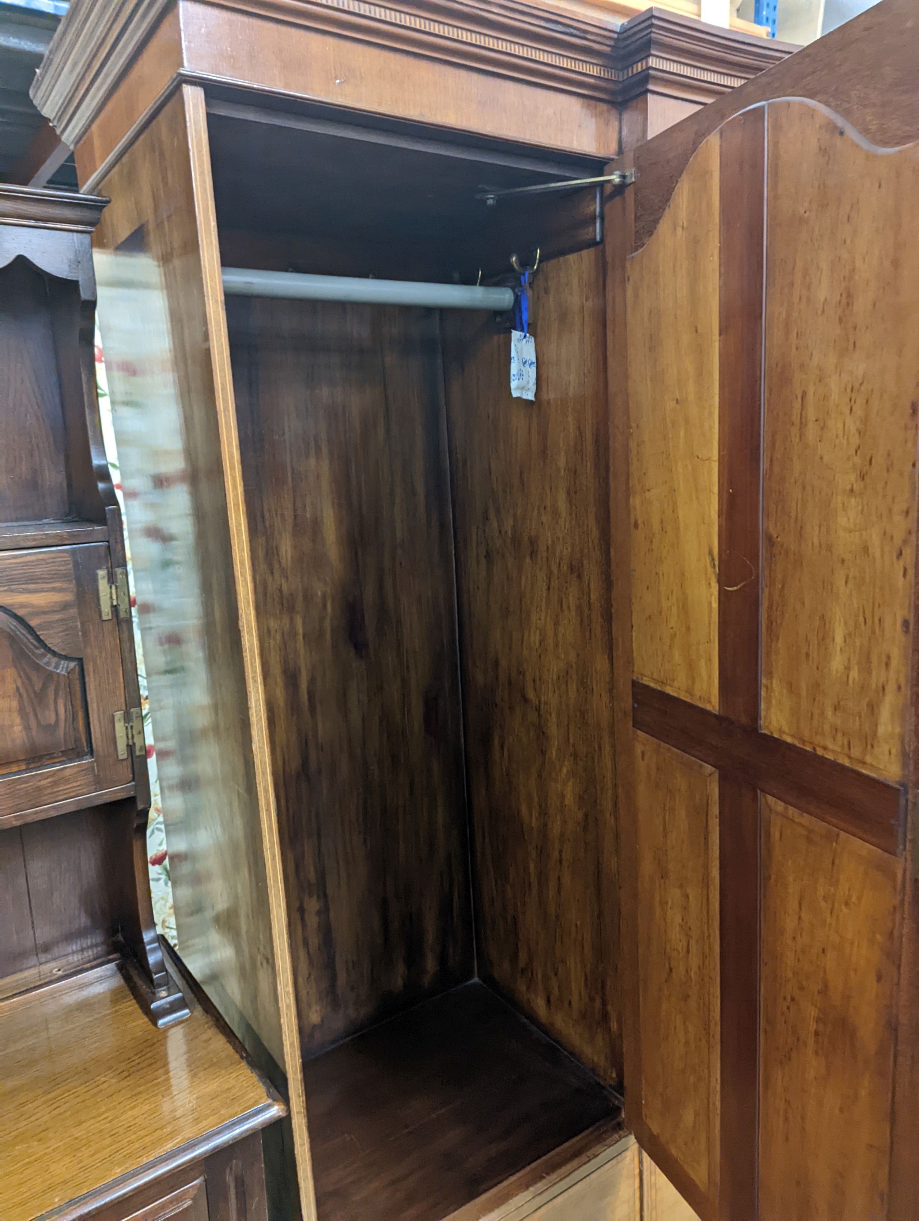 An Edwardian satinwood banded mahogany compactum wardrobe, length 136cm, depth 56cm, height 210cm